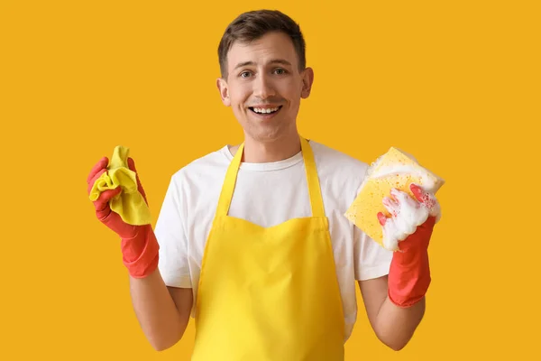 Young Man Cleaning Sponge Rag Yellow Background — Stockfoto