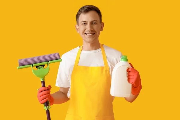 Young Man Mop Detergent Yellow Background — Stockfoto