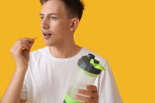 Young Man Bottle Water Vitamin Yellow Background — Fotografia de Stock
