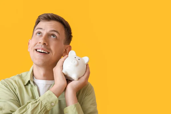 Young Man White Piggy Bank Yellow Background — Φωτογραφία Αρχείου