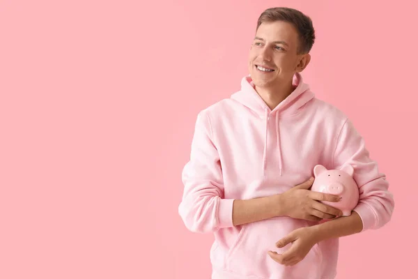Smiling Young Man Piggy Bank Pink Background — 스톡 사진