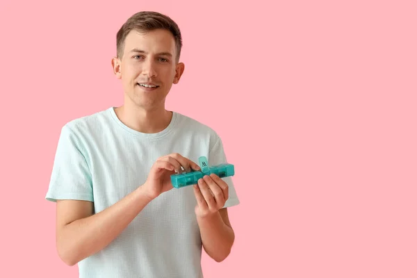 Young Man Holding Container Pills Pink Background — Φωτογραφία Αρχείου