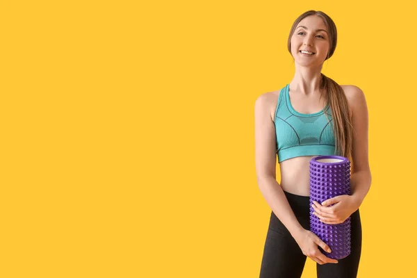 Young Woman Purple Foam Roller Yellow Background — Stockfoto