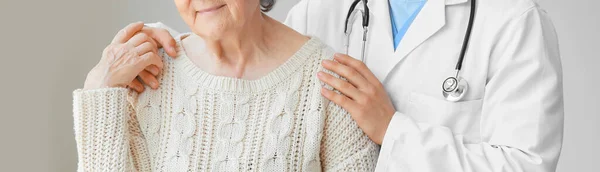 Senior Woman Doctor Grey Background — стоковое фото