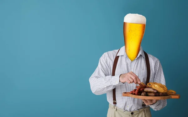 Man in traditional German clothes, with glass of beer instead of his head and snacks on blue background. Octoberfest celebration