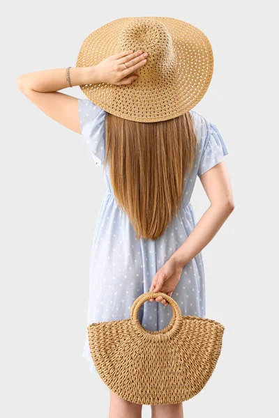 Young Woman Wicker Hat Holding Rattan Handbag Light Background — Foto de Stock