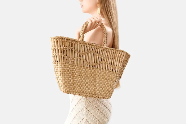 Elegant Woman Dress Holding Rattan Handbag Light Background — стоковое фото