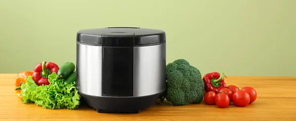 Modern Multi Cooker Vegetables Table Green Background — Fotografie, imagine de stoc