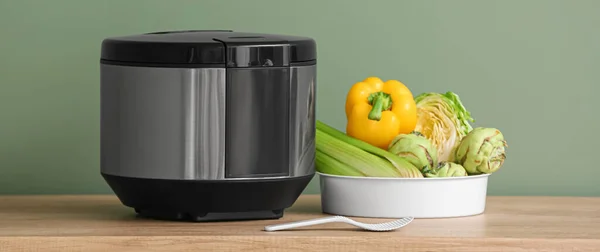 Modern Multi Cooker Vegetables Table Green Background — Stockfoto