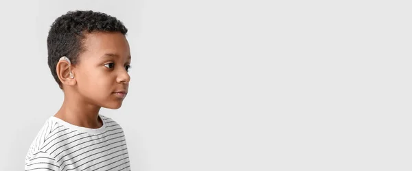 Little African American Boy Hearing Aid Light Background Banner Design — Zdjęcie stockowe