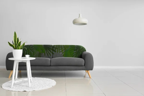 Comfortable Sofa Print Monstera Leaves Table Light Wall Room — стоковое фото