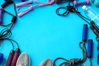 Mavi arkaplanda pilates için farklı ekipmanlardan yapılmış çerçeve