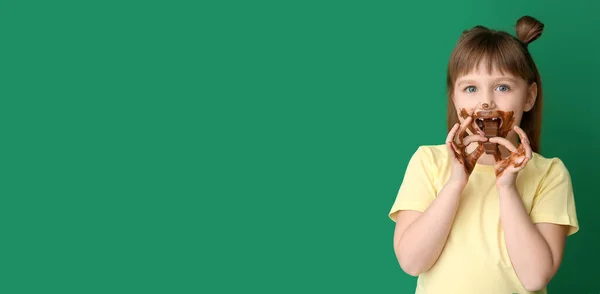 Cute Little Girl Dirty Face Hands Eating Chocolate Green Background — стоковое фото