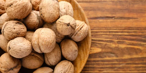 Plate Tasty Walnuts Wooden Background Space Text Closeup — стоковое фото