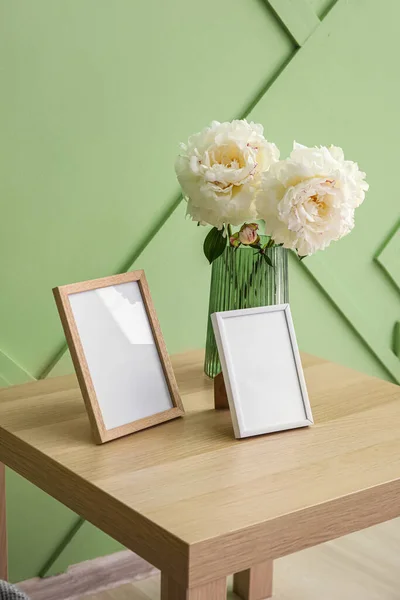 Blank Photo Frames Vase Bouquet Peony Flowers Table Green Wall — Stockfoto