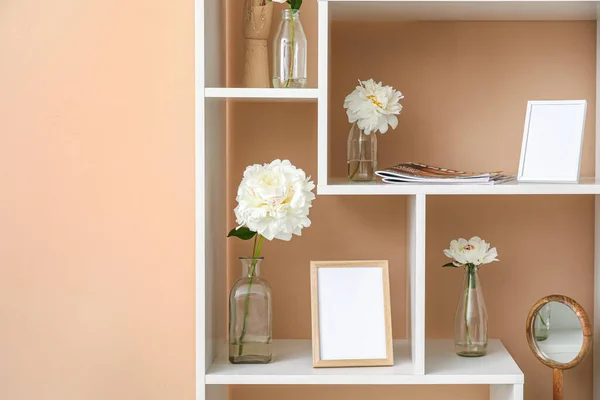 Shelf Unit Blank Photo Frames Beautiful Peony Flowers Beige Wall — Stock Photo, Image