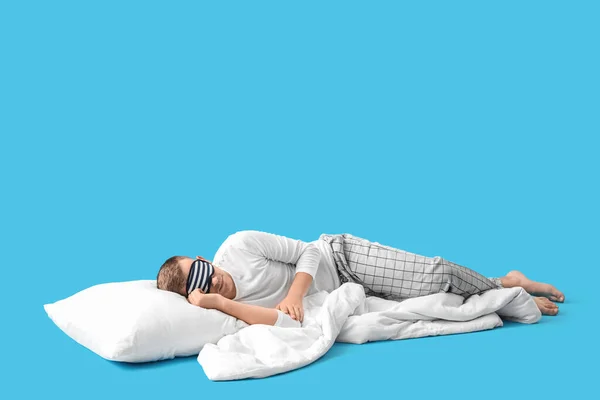 Young Man Sleeping Mask Pillow Blanket Lying Blue Background — Stockfoto