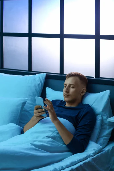 Young Man Using Mobile Phone Bedroom Night — Fotografia de Stock