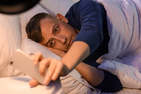 Young Man Using Mobile Phone Bedroom Night — Foto Stock