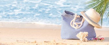 Beach accessories on sand near sea. Banner for design