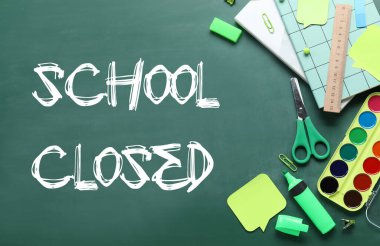 Stationery with written text SCHOOL CLOSED on chalkboard
