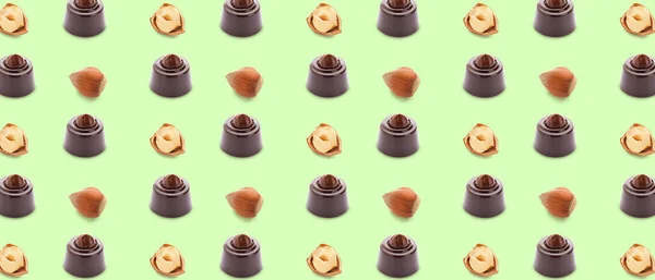 Many Tasty Chocolate Candies Nuts Green Background Pattern Design — Φωτογραφία Αρχείου