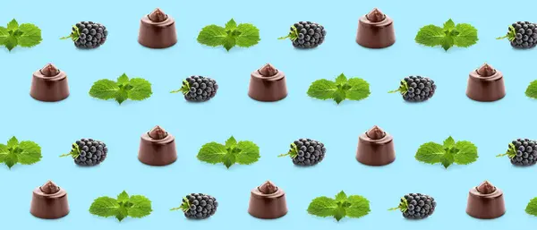 Many Tasty Chocolate Candies Blackberries Mint Light Blue Background Pattern — стоковое фото