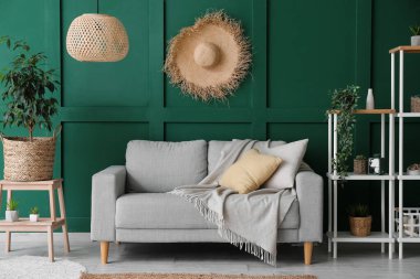 Interior of cozy living room with sofa, stepladder and shelving unit
