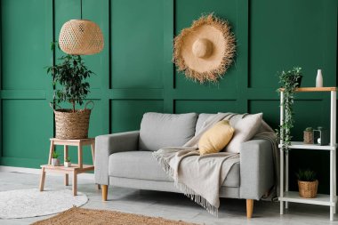 Interior of cozy living room with sofa, stepladder and shelving unit