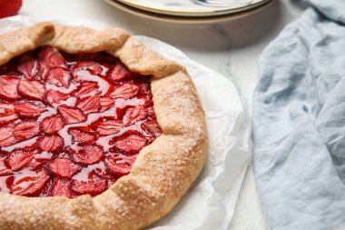 Delicious strawberry galette on light background, closeup