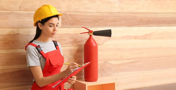 Fire safety specialist inspecting extinguisher in premises