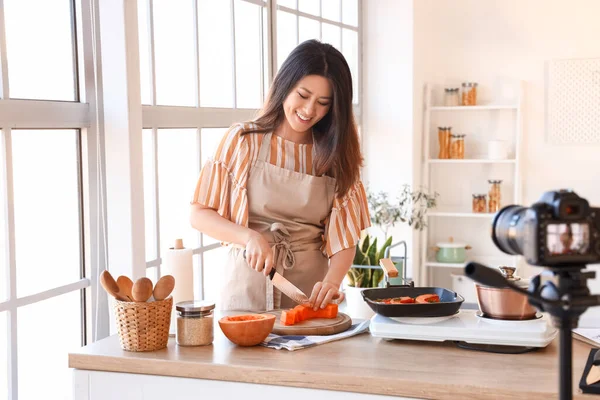 Young Asian Woman Cutting Pumpkin While Recording Video Class Kitchen — Stok fotoğraf