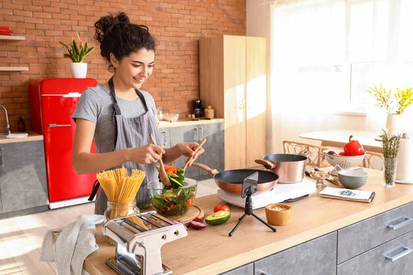 Young Woman Making Tasty Salad While Watching Cooking Video Tutorial — Stock Photo, Image