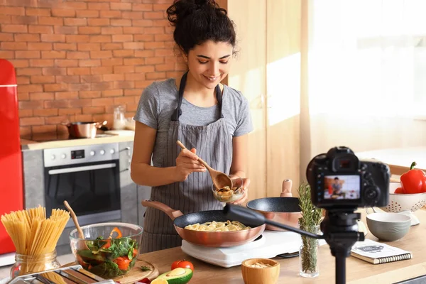 Young Woman Adding Mussels Pasta While Recording Cooking Video Class — Stok fotoğraf