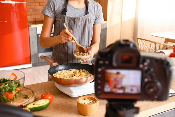 Young Woman Adding Mussels Pasta While Recording Cooking Video Class — Stock fotografie