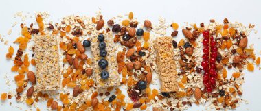 Tasty granola bars on light background, top view