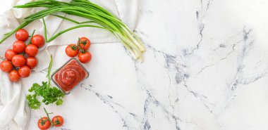 Bowl of organic tomato sauce on white background with space for text