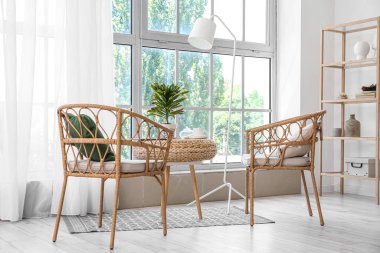 Wilted houseplant with cup of coffee and magazine on table in living room