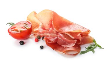 Delicious sliced jamon, spices and tomato on white background