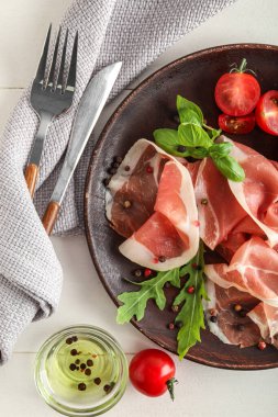 Plate with delicious jamon on table, closeup