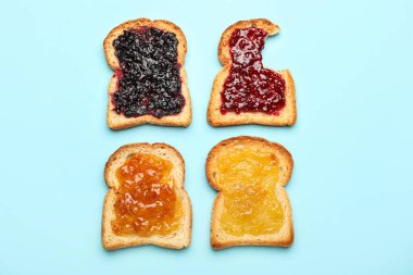Toasts with different jams on color background