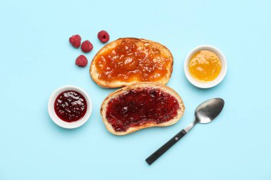 Composition with toasts and bowls of jams on color background