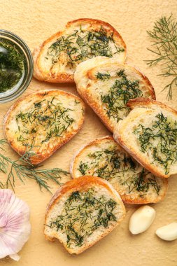 Delicious toasts with garlic and dill on color background