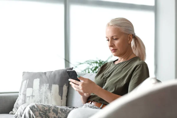 Mature Female Soldier Using Mobile Phone Home — Photo