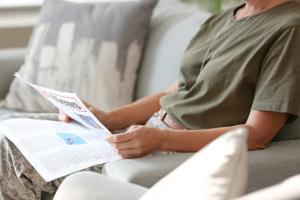 Mature Female Soldier Reading Newspaper Home — Foto de Stock