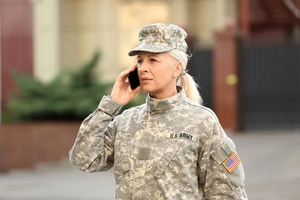 Mature Female Soldier Talking Mobile Phone Outdoors — Stockfoto