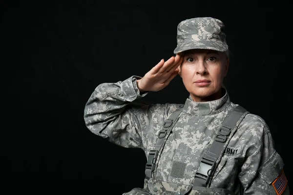 Mature Female Soldier Saluting Black Background — Stockfoto