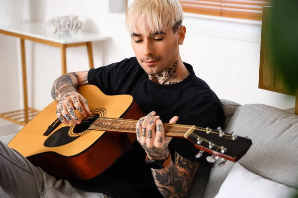 Young Tattooed Man Playing Guitar Sofa Home —  Fotos de Stock
