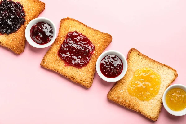 Delicious Toasts Bowls Jam Pink Background Closeup — стоковое фото