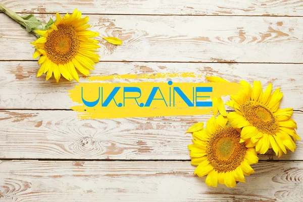 Beautiful Sunflowers Word Ukraine White Wooden Background — стокове фото